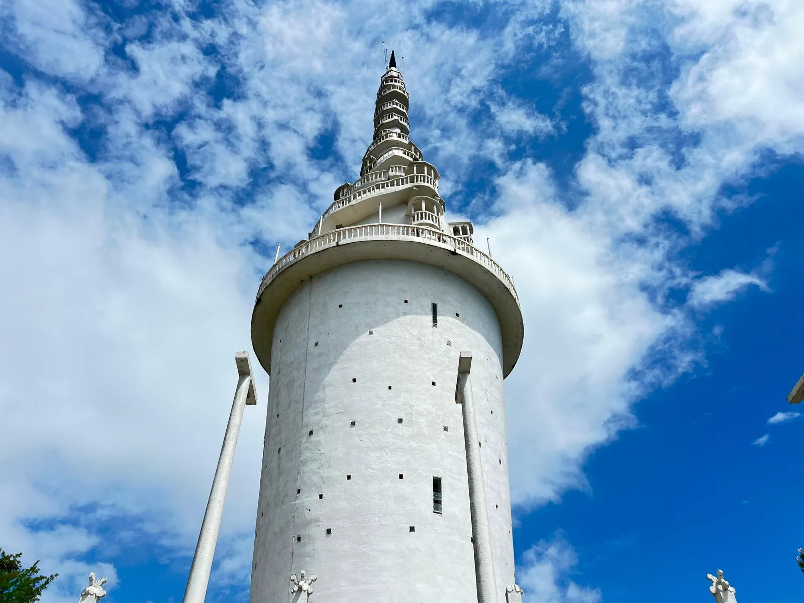 A white tower with a spiralling staircase and viewing platforms winding to its pinnacle